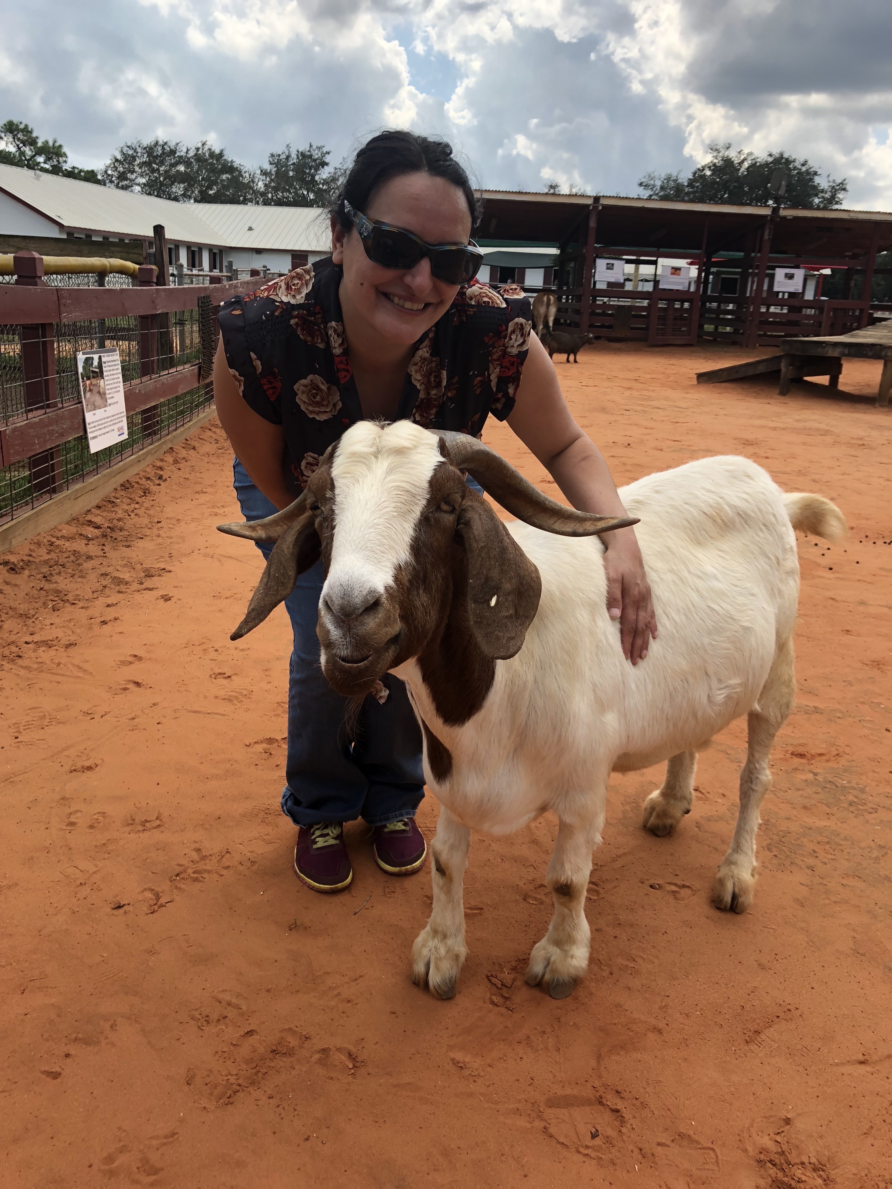 Lisa Gonzalez standing next to goat. 