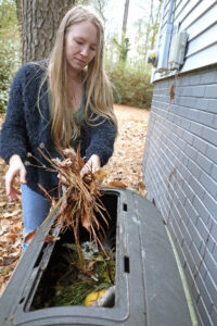 Woman using compost bin