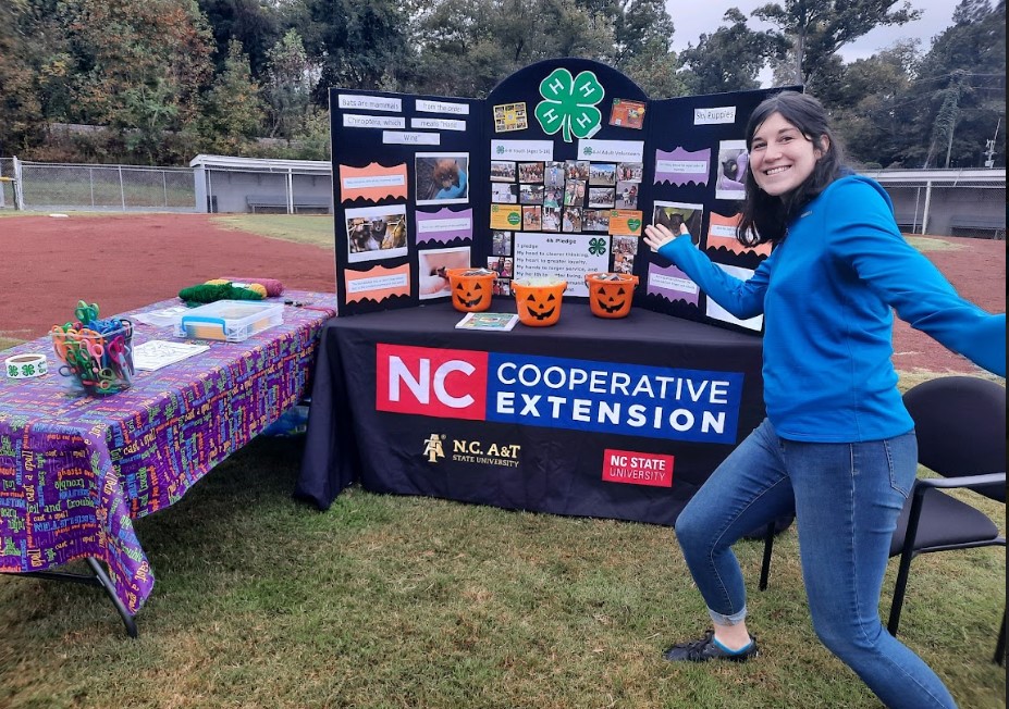 Kaitlyn Lamaster shows off an NCCE display at an event.