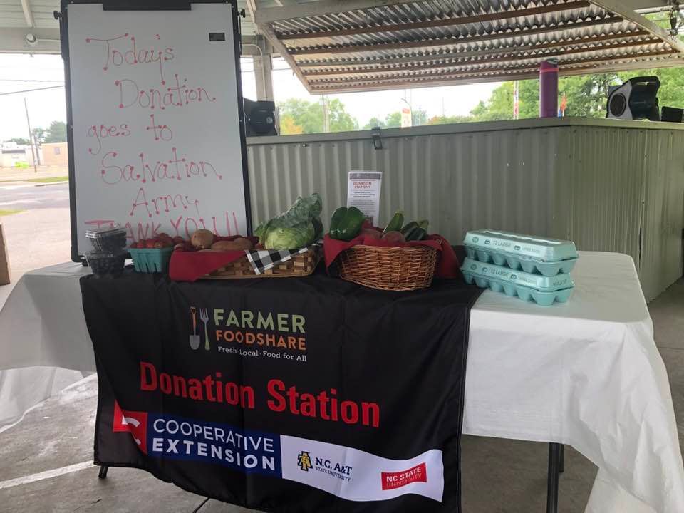 The Farmer Foodshare donation station with food goods displayed on it.