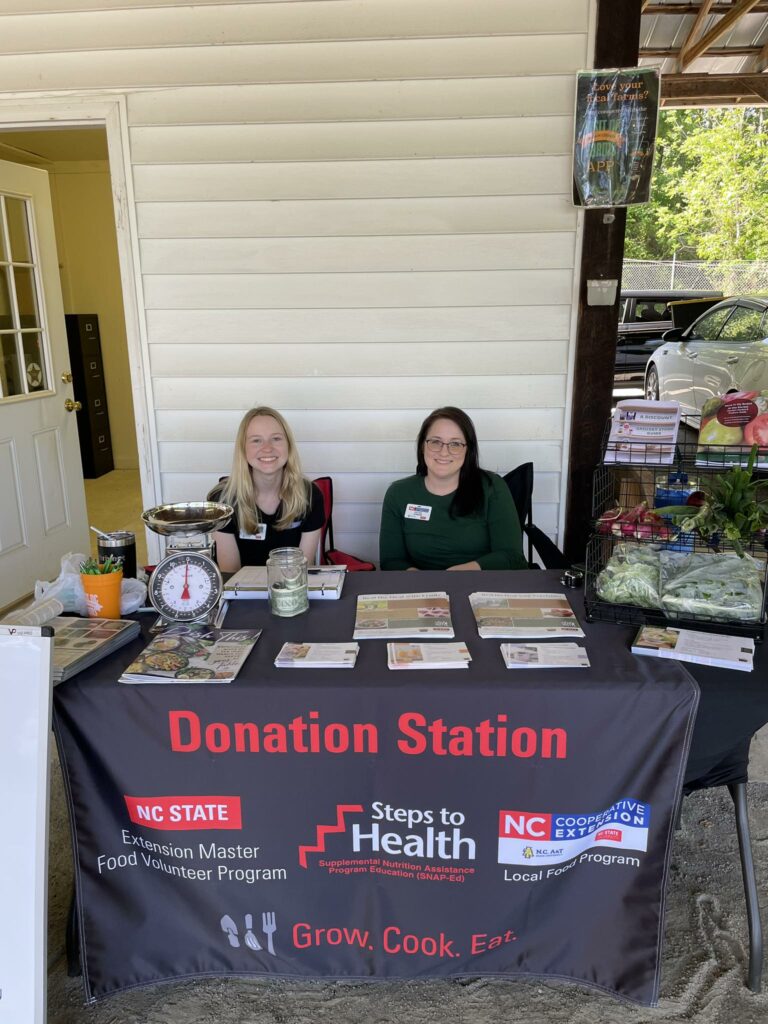 Chelsea Johnson and Kellee Payne sitting at the Yadkin County Donation Station